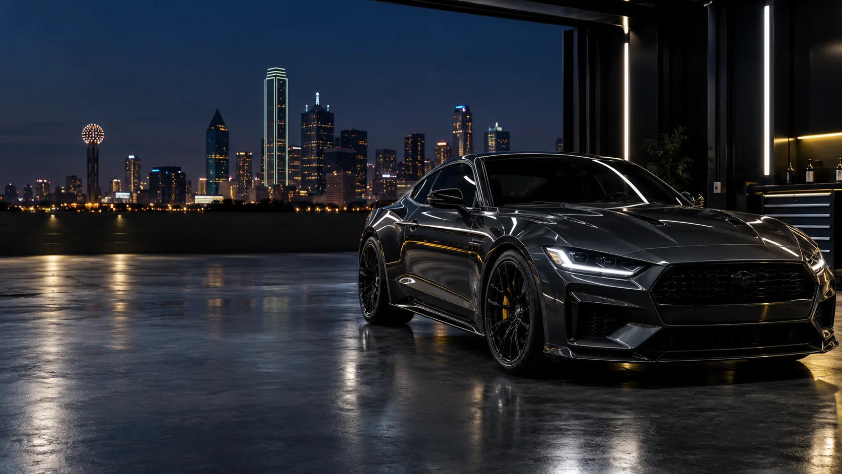 Dark graphite performance coupe in a premium protection studio at night